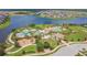 Aerial view of resort-style community pool, clubhouse, and playground near a lake in residential neighborhood at 9440 Lemon Drop Loop, Sun City Center, FL 33573