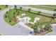 Aerial view of dog park with green space, walking path, trees, and black fence at 9440 Lemon Drop Loop, Sun City Center, FL 33573