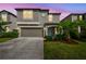 Charming two-story home featuring a well-kept lawn, attached garage, and lovely front yard landscaping at 9440 Lemon Drop Loop, Sun City Center, FL 33573