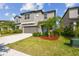 Well-manicured front yard with lush landscaping and a two-story home with gray exterior at 9440 Lemon Drop Loop, Sun City Center, FL 33573
