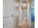 Long hallway with carpet floors and neutral paint at 9440 Lemon Drop Loop, Sun City Center, FL 33573