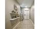 Inviting hallway with tiled flooring, stylish decor, and access to the staircase and living area at 9440 Lemon Drop Loop, Sun City Center, FL 33573