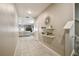 Entry hallway featuring tiled floors, decorative shelves, and an open view to the living area at 9440 Lemon Drop Loop, Sun City Center, FL 33573