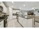 Bright and spacious kitchen featuring granite counters, stainless steel appliances, white cabinets, and an island at 9440 Lemon Drop Loop, Sun City Center, FL 33573