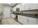 Well-equipped kitchen features granite counters, stainless steel appliances, and white cabinets for ample storage at 9440 Lemon Drop Loop, Sun City Center, FL 33573