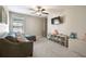 Comfortable living room with a large sectional, ceiling fan, a TV, and plenty of space for relaxing and play at 9440 Lemon Drop Loop, Sun City Center, FL 33573