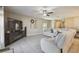 Bright living room featuring tiled floors, a comfortable sofa, and stylish decor at 9440 Lemon Drop Loop, Sun City Center, FL 33573