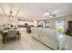 Spacious living area with an open floor plan, tiled flooring, a dining area, and modern furnishings at 9440 Lemon Drop Loop, Sun City Center, FL 33573