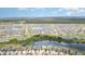 Expansive aerial view showcasing a Primary-planned community with multiple lakes and lush landscaping at 9514 Channing Hill Dr, Sun City Center, FL 33573