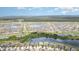 Expansive aerial view showcasing a Primary-planned community with multiple lakes and lush landscaping at 9514 Channing Hill Dr, Sun City Center, FL 33573
