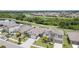 Aerial view of a well-maintained neighborhood with lush greenery and a serene lake at 9514 Channing Hill Dr, Sun City Center, FL 33573