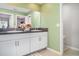 Bathroom with double sinks, granite countertops, and decorative accents at 9514 Channing Hill Dr, Sun City Center, FL 33573