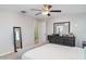 Bright bedroom featuring a ceiling fan, a dresser, and a comfortable-looking bed at 9514 Channing Hill Dr, Sun City Center, FL 33573