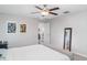 Minimalist bedroom design with neutral tones, simple decor, and a ceiling fan at 9514 Channing Hill Dr, Sun City Center, FL 33573