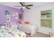 Vibrant bedroom with two beds, decorated with colorful wall art at 9514 Channing Hill Dr, Sun City Center, FL 33573