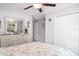 Bedroom with a ceiling fan, dresser and closet space at 9514 Channing Hill Dr, Sun City Center, FL 33573