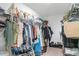 Walk-in closet well-stocked with an abundance of clothes and shoes at 9514 Channing Hill Dr, Sun City Center, FL 33573