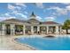 View of the community pool and clubhouse provides a luxury living experience at 9514 Channing Hill Dr, Sun City Center, FL 33573