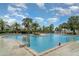 Sparkling community pool features a splash pad and easy-access with a pool lift for residents at 9514 Channing Hill Dr, Sun City Center, FL 33573