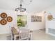Charming dining room with a rustic table, decorative wall art, and bright natural light at 9514 Channing Hill Dr, Sun City Center, FL 33573