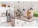 Spacious kitchen island with stainless appliances and granite countertops overlooks the dining and living areas at 9514 Channing Hill Dr, Sun City Center, FL 33573