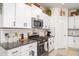 Well-equipped kitchen with granite counters, stainless steel appliances, and white subway tile backsplash at 9514 Channing Hill Dr, Sun City Center, FL 33573
