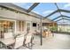Stylish patio featuring ample seating, dining area, mounted TV, and decorative hanging plants at 9514 Channing Hill Dr, Sun City Center, FL 33573