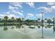 Tennis court with palm trees and a covered bench provides a great recreational amenity at 9514 Channing Hill Dr, Sun City Center, FL 33573