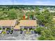 Aerial view of condo complex nestled among lush greenery with ample parking at 9804 Lombard Ct # 104, Tampa, FL 33618