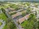 Aerial view shows a residential community with a pool, roads, and mature trees at 9804 Lombard Ct # 104, Tampa, FL 33618