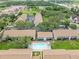 A lovely community aerial view shows a sparkling pool, mature trees, and multiple units at 9804 Lombard Ct # 104, Tampa, FL 33618