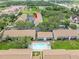 A lovely community aerial view shows a sparkling pool, mature trees, and the unit indicated by the arrow at 9804 Lombard Ct # 104, Tampa, FL 33618