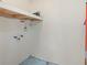 Unfinished basement with painted block walls, utility connections, and open shelf at 9804 Lombard Ct # 104, Tampa, FL 33618