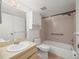 Clean bathroom with vanity, toilet, and shower/tub with handrail, providing accessibility at 9804 Lombard Ct # 104, Tampa, FL 33618