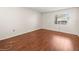 An empty bedroom with a window and sleek wood flooring, offering ample space at 9804 Lombard Ct # 104, Tampa, FL 33618