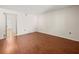 Empty bedroom features sleek wood flooring, ample light and two electrical outlets at 9804 Lombard Ct # 104, Tampa, FL 33618