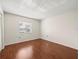 Empty bedroom features sleek wood flooring, a large window and a closet at 9804 Lombard Ct # 104, Tampa, FL 33618