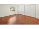 Spacious bedroom with sleek wood flooring and large closets, offering plenty of storage at 9804 Lombard Ct # 104, Tampa, FL 33618