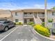 Exterior shot of a condo with parking and stairs leading to upper units at 9804 Lombard Ct # 104, Tampa, FL 33618