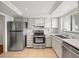 Kitchen showcases stainless steel appliances, tile flooring, and ample counter space at 9804 Lombard Ct # 104, Tampa, FL 33618