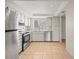Bright kitchen features stainless steel appliances, tile floors, and white cabinetry at 9804 Lombard Ct # 104, Tampa, FL 33618