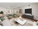 Bright living room featuring modern furniture and open floor plan to kitchen at 9804 Lombard Ct # 104, Tampa, FL 33618