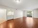 Bright living room with wood floors, wet bar, and sliding glass doors to the outside at 9804 Lombard Ct # 104, Tampa, FL 33618