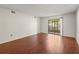 Spacious living room featuring wood floors and natural light from sliding glass doors at 9804 Lombard Ct # 104, Tampa, FL 33618