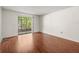 Sunlit living room with wood floors and sliding glass doors to the lanai at 9804 Lombard Ct # 104, Tampa, FL 33618