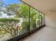 Screened porch with tile floor offers serene views of the landscaped backyard at 9804 Lombard Ct # 104, Tampa, FL 33618