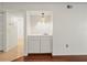 Conveniently located wet bar with sink, cabinet storage, and modern lighting at 9804 Lombard Ct # 104, Tampa, FL 33618
