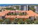 An aerial view of a multi-story building complex with a terracotta-tiled roof and lush green trees at 100 4Th S Ave # 312, St Petersburg, FL 33701