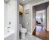Bathroom with a clean design featuring a bathtub, toilet, cabinet, and an ensuite bathroom visible through a door at 100 4Th S Ave # 312, St Petersburg, FL 33701