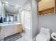 Bright bathroom featuring a bathtub, toilet and modern vanity with marble counters at 100 4Th S Ave # 312, St Petersburg, FL 33701